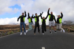 Happy people jumping in the air on Mount Teide in Tenerife