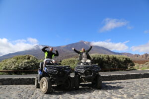 two people with hands in the air on Mount Teide with Quads